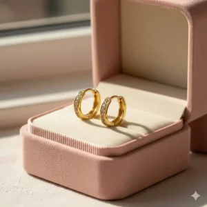 Sparkly small 14k gold huggie earrings for girls with tiny inset diamonds.