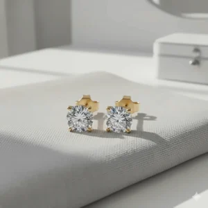 Close-up of classic 14k gold stud earrings with a single diamond or cubic zirconia, ideal for everyday wear.