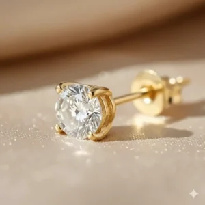 Detailed view of the diamond stud earrings showcasing the secure 14k yellow gold four-prong basket setting.