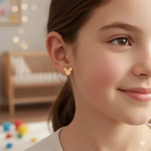 Little girl wearing dainty Disney 14k gold earrings, illustrating the perfect size and fit.