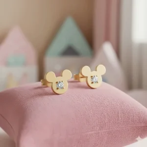 Close-up of charming 14k gold Mickey Mouse earrings, a classic Disney gift for young girls.