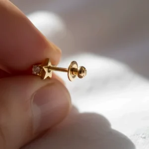 Secure screw-back mechanism on 14k gold earrings for girls for added safety and comfort.