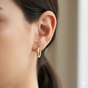 Elegant and simple small 18k gold hoop earrings perfect for everyday wear.