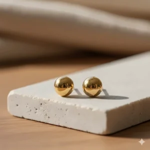 The 14k gold stud earrings photographed in soft natural light to highlight their brilliance and shine.