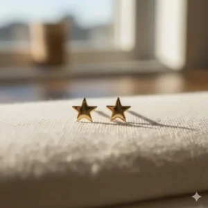 Celestial-themed tiny 14k gold stud earrings shaped like small, five-pointed stars.