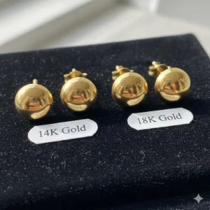 Detail showing the difference between 14k and 18k gold earrings for men, highlighting the material quality.