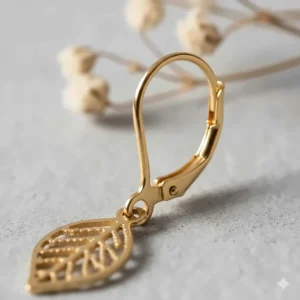 Close-up view of the secure lever-back closure on a pair of gold drop earrings.