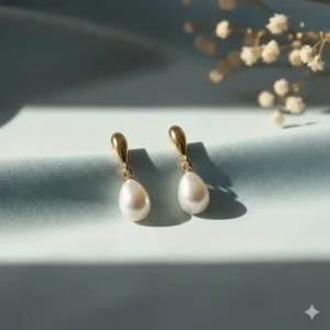 Classic gold drop earrings with a single teardrop-shaped white freshwater pearl.