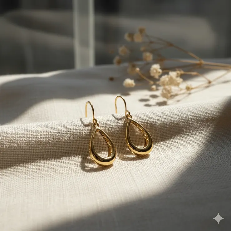 Delicate hollow gold drop earrings in a classic teardrop dangle style.