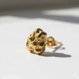 Solid gold nugget earrings for men featuring a rustic, textured finish. A single large nugget stud is shown in high detail on a white background.