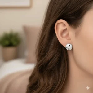 Macro shot highlighting the unique hammered texture on the surface of the 10 karat gold earrings.