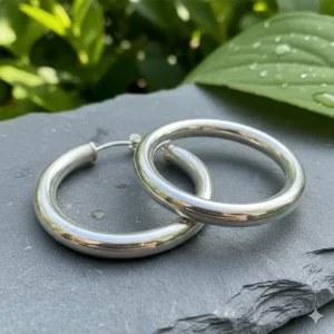 Pair of sterling silver extra large hoop earrings with a high-shine finish.