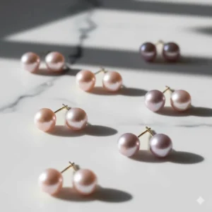 A collection of natural pink and lavender freshwater pearl stud earrings displayed together.