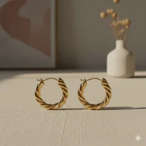 Modern twisted design on medium gold hoop earrings featuring a unique braided texture.