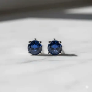 Natural blue sapphire stud earrings in a minimalist white gold basket setting.