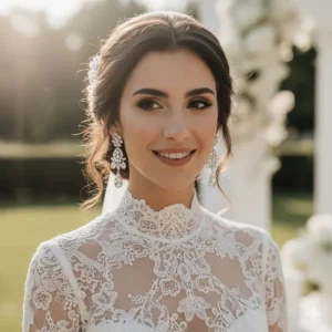 A bride wearing intricate vintage-style crystal chandelier earrings with a white lace wedding dress.