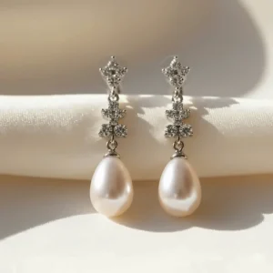 Elegant bridal long dangle earrings featuring drop pearls and sparkling crystals.