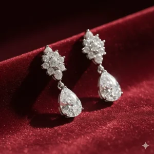 Luxurious diamond teardrop long dangle earrings reflecting light against a velvet background.