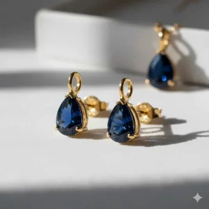 Unique pear-cut navy blue sapphire earrings in a 18k yellow gold setting.