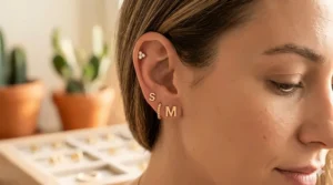 A pair of gold initial stud earrings presented in a luxury velvet jewelry box, ideal for personalized gifting.
