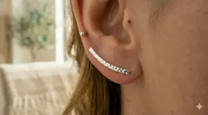 Close-up of bar ear climbers with a textured hammered metal finish for a boho-chic style.