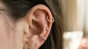 Three different helix earrings displayed in 14k gold, sterling silver, and surgical steel to show material options.