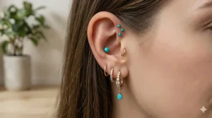 Inspiring curated ear design combining a forward helix stud with lobe and conch piercings.