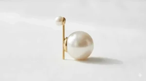 Side profile of front back pearl earrings showing the unique double-sided design.