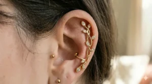 An intricate leaf-shaped ear climber designed to follow the curve of the outer ear cartilage.