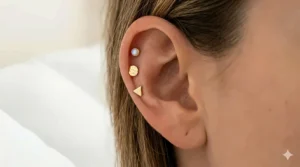 Minimalist 14k gold studs for helix piercings designed with smooth edges to prevent catching on pillowcases.