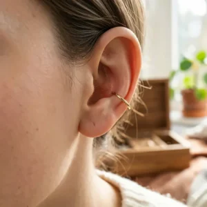 Illustration of a small seamless gold hoop earring designed as a lightweight, snag free comfortable tragus earring alternative.