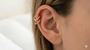 Illustration of small, seamless gold huggie hoops that fit snugly against the ear for comfortable side sleeping.