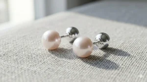 Sterling silver front back pearl earrings, also known as pearl ear jackets, on a white background.